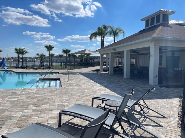 community pool featuring a ceiling fan, a patio area, and fence