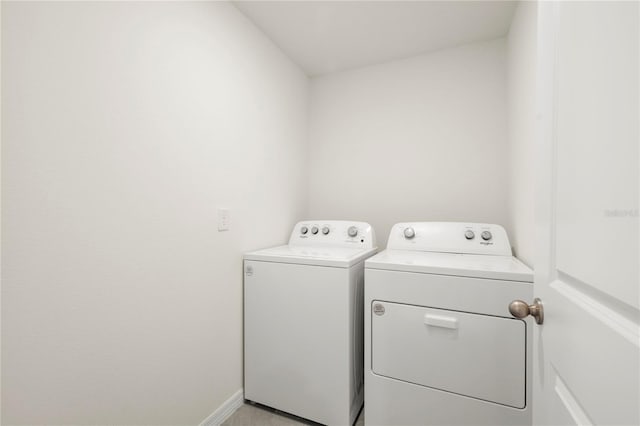 laundry room featuring baseboards, laundry area, and washer and dryer