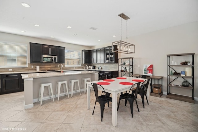 tiled dining room featuring sink