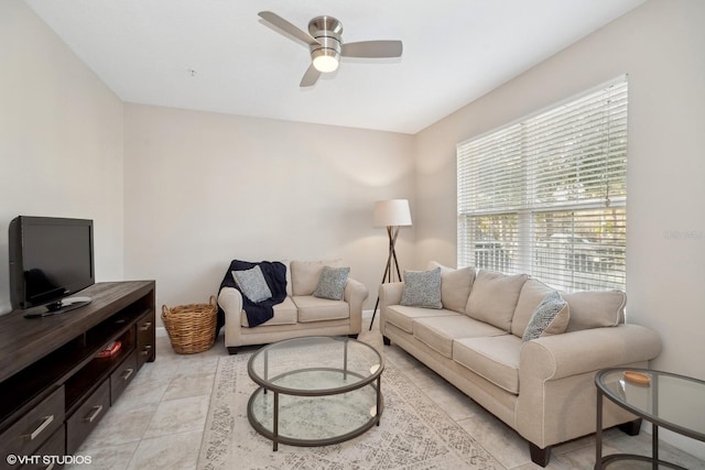 living room with ceiling fan and light tile patterned flooring