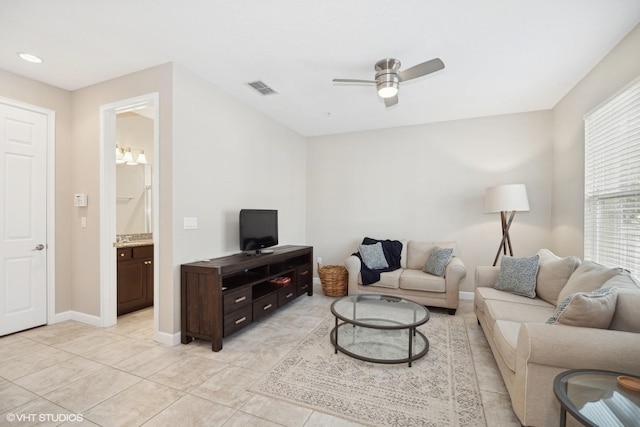 living room with ceiling fan and light tile patterned floors