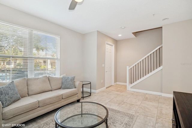 tiled living room with ceiling fan