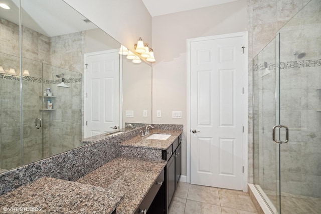 bathroom featuring tile patterned flooring, vanity, and walk in shower