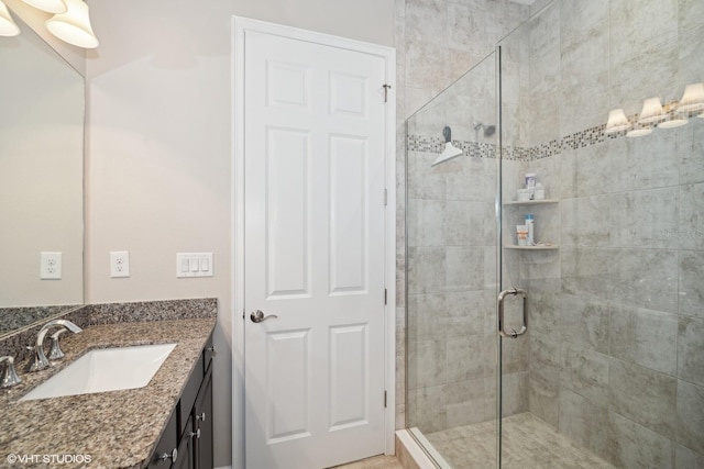 bathroom featuring vanity and an enclosed shower