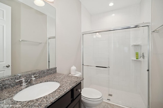 bathroom featuring vanity, toilet, and walk in shower