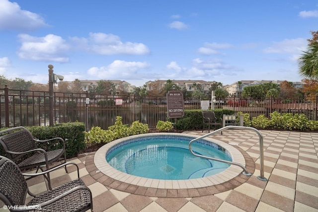 view of swimming pool with a hot tub and a patio area