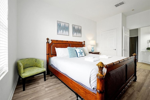 bedroom featuring light hardwood / wood-style floors and multiple windows