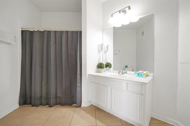 bathroom featuring tile patterned flooring and vanity