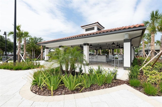 view of home's community featuring a gazebo, an outdoor bar, and a patio