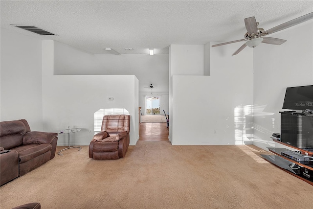 living room featuring light colored carpet and a textured ceiling