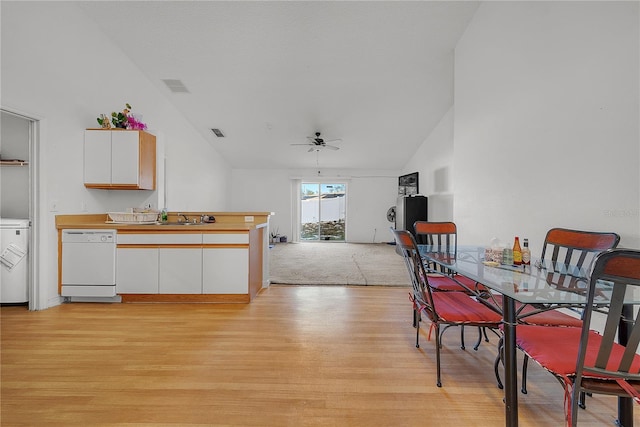 dining space with ceiling fan, light wood-type flooring, sink, and lofted ceiling