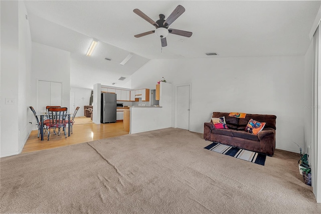 carpeted living room with ceiling fan and lofted ceiling