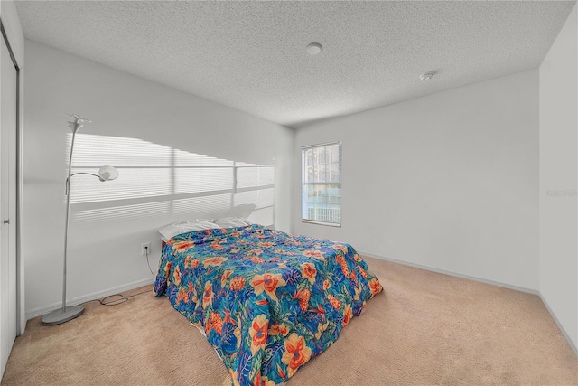 carpeted bedroom with a textured ceiling