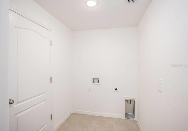 washroom with hookup for an electric dryer, light tile patterned flooring, and hookup for a washing machine