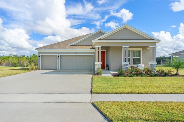 view of front of home with a garage, covered porch, and a front lawn