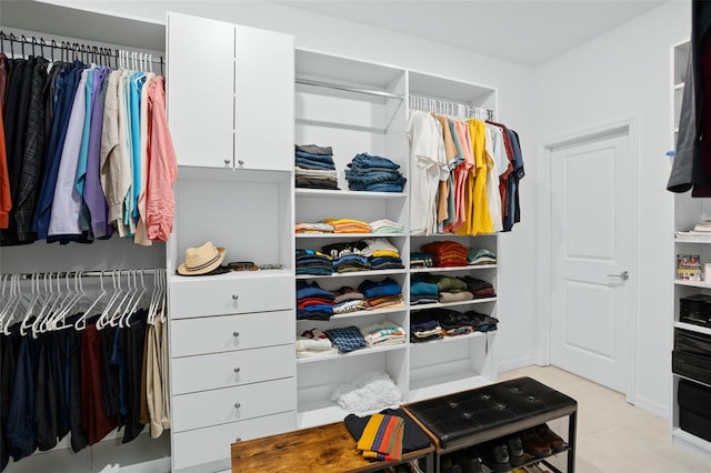 spacious closet with light tile patterned floors