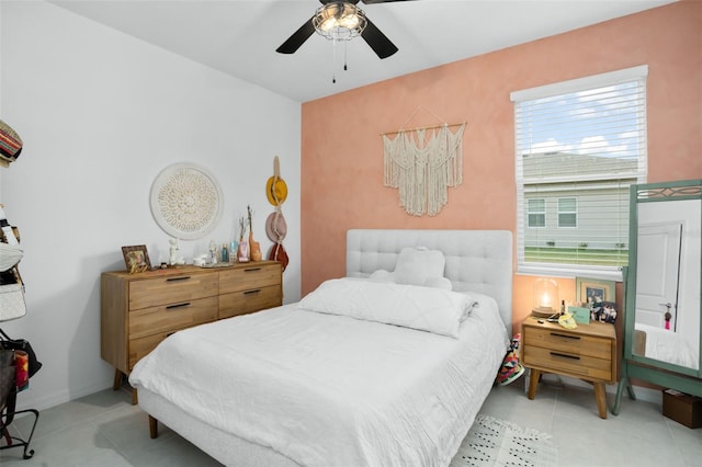 bedroom featuring light tile patterned floors and ceiling fan