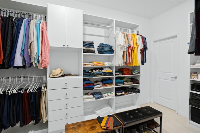 spacious closet featuring light tile patterned floors