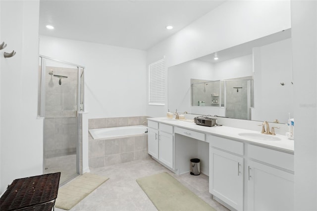 full bathroom with a garden tub, double vanity, recessed lighting, a shower stall, and a sink