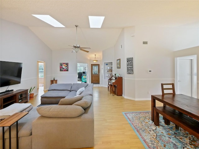 living room with ceiling fan, high vaulted ceiling, and light hardwood / wood-style flooring