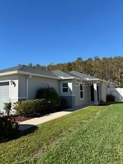 view of property exterior with a garage and a yard