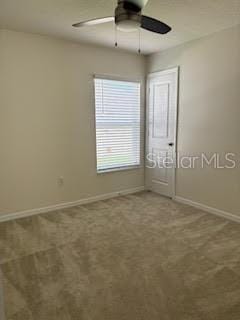 empty room with ceiling fan and carpet floors