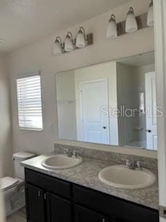 bathroom featuring vanity and toilet