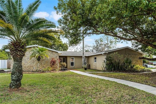 ranch-style house featuring a front lawn