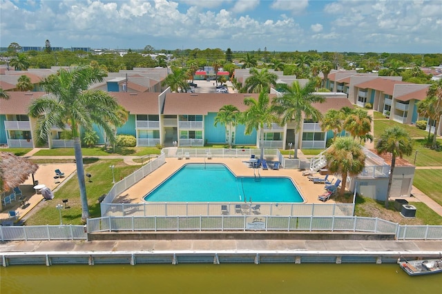 view of pool featuring a patio area and a water view