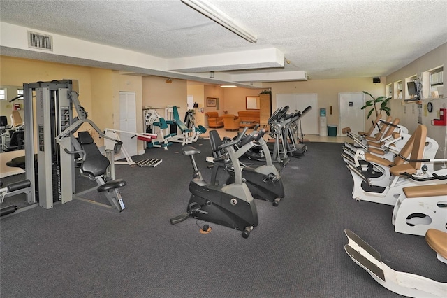 exercise room with a textured ceiling