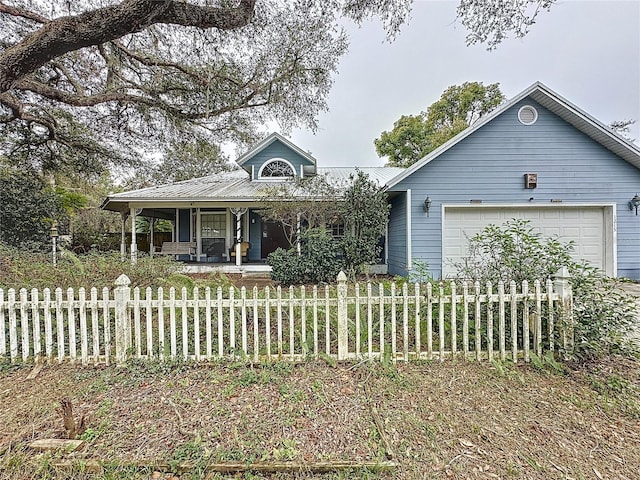 view of front of property with covered porch and a garage