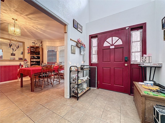 foyer featuring light tile patterned flooring and a chandelier