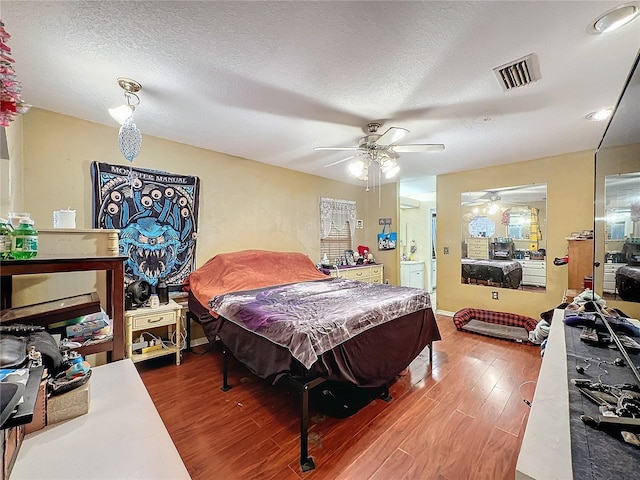 bedroom with ceiling fan, wood-type flooring, a textured ceiling, and billiards