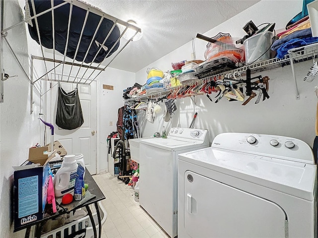 laundry area featuring washer and dryer and a textured ceiling