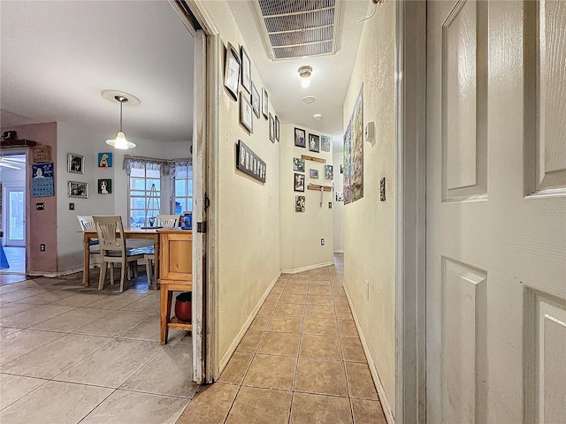 hall with light tile patterned flooring