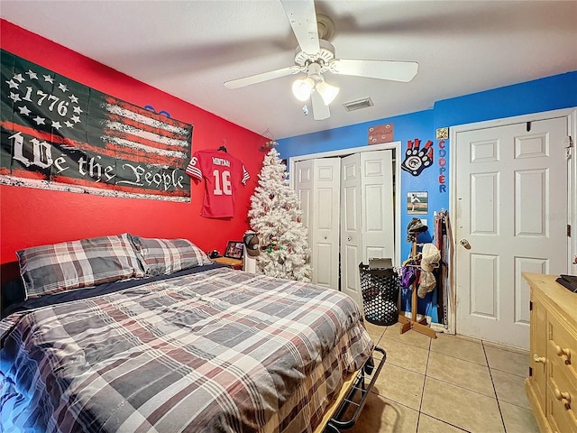 tiled bedroom featuring ceiling fan