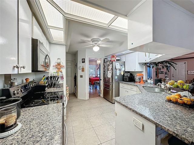 kitchen featuring sink, ceiling fan, light tile patterned flooring, white cabinetry, and stainless steel appliances