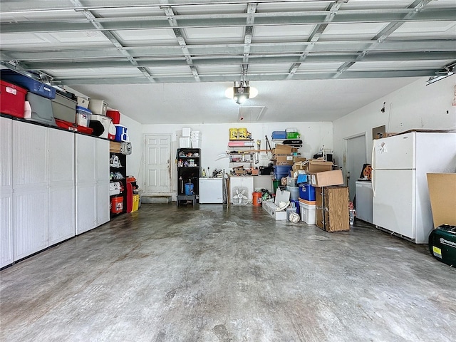 garage with a garage door opener and white refrigerator