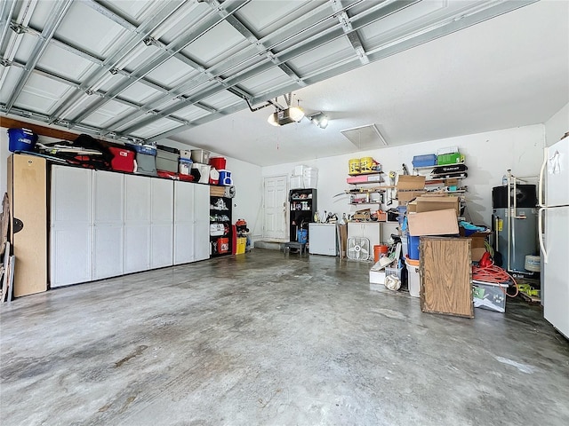 garage featuring heat pump water heater and a garage door opener