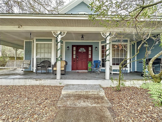 doorway to property featuring covered porch