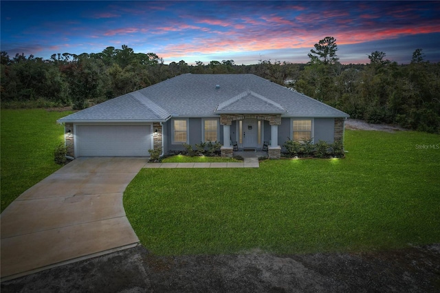 view of front of house featuring a yard and a garage