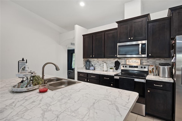 kitchen featuring tasteful backsplash, sink, and stainless steel appliances