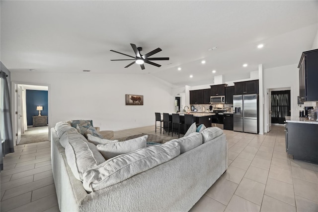 tiled living room with vaulted ceiling and ceiling fan