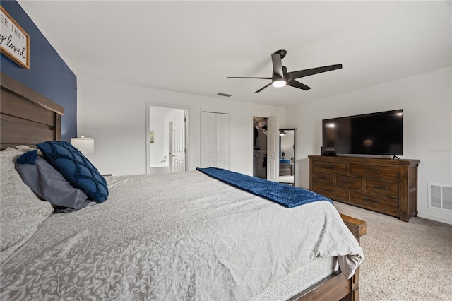 bedroom featuring carpet, ceiling fan, ensuite bathroom, and a closet