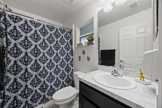 bathroom with vanity, a textured ceiling, and toilet