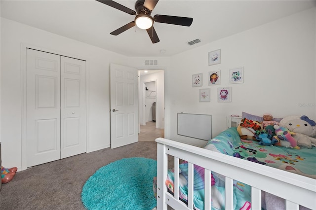 carpeted bedroom featuring ceiling fan and a closet