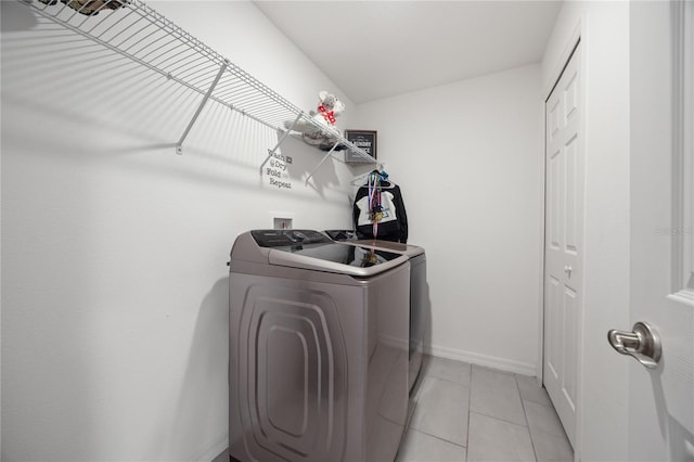 laundry area featuring light tile patterned flooring and independent washer and dryer