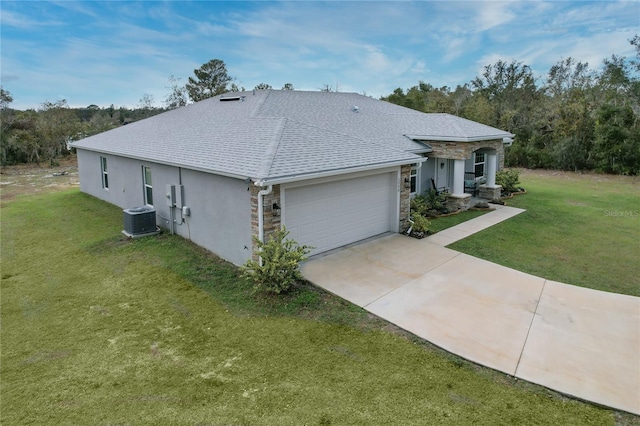 ranch-style house with a front yard, a garage, and cooling unit