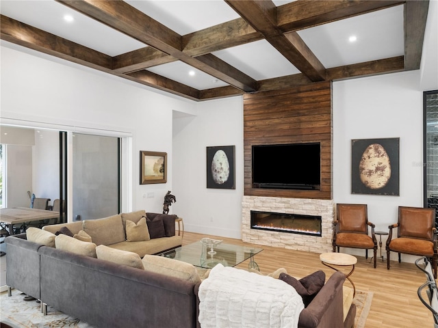 living room featuring a fireplace, beamed ceiling, light hardwood / wood-style flooring, and coffered ceiling