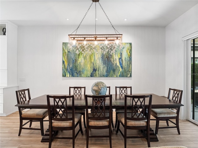 dining area with a chandelier and wood-type flooring